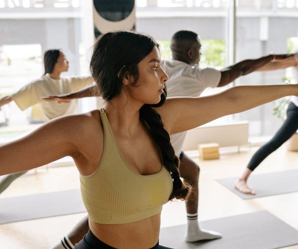 Person holding a warrior yoga pose, demonstrating balance and strength.